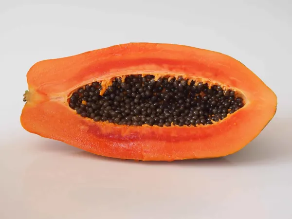 a papaya cut in half before being prepared for babies starting solids
