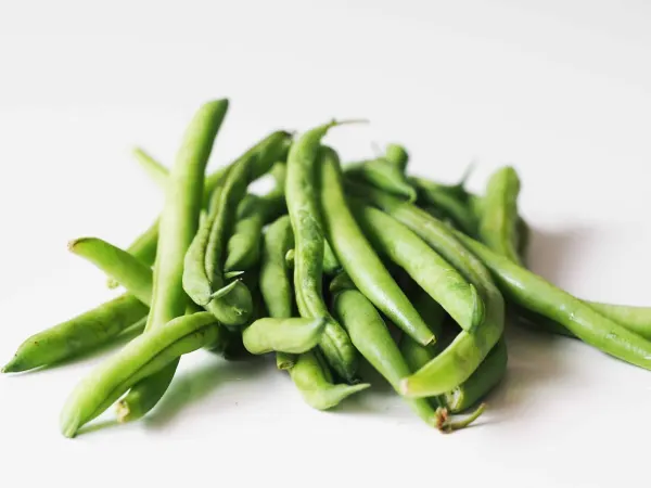 a pile of fresh green beans on a table before being prepared for babies starting solids