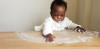 Baby smears yogurt on a table