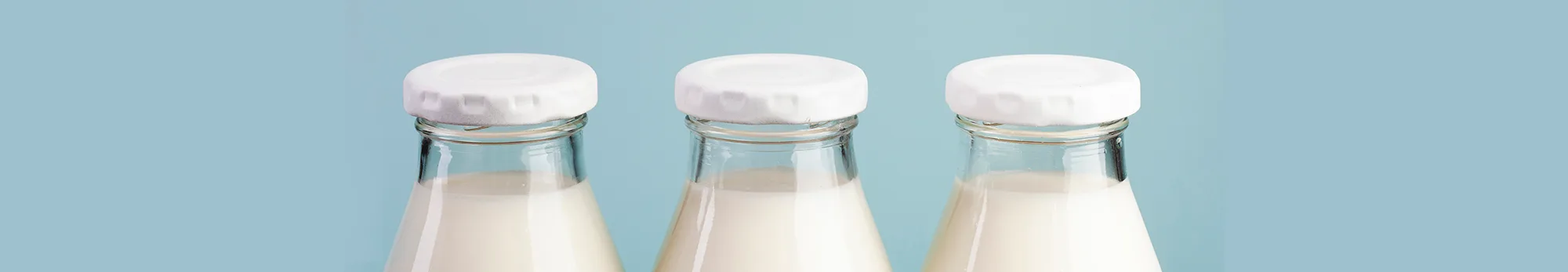 Milk for Babies and Toddlers Three glass bottles of milk