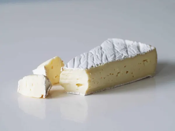 a wedge of brie with the tip cut off and placed to the side