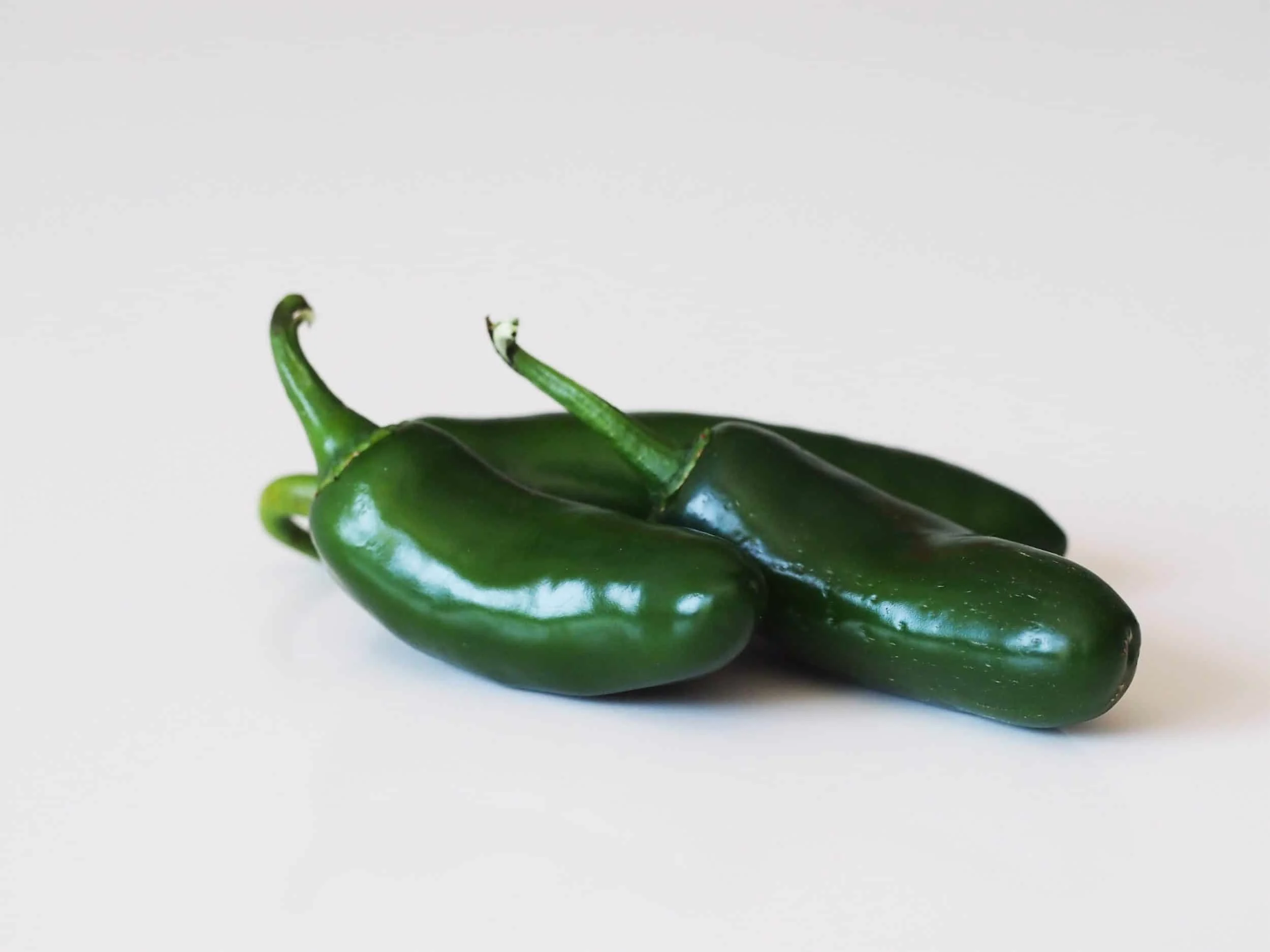Three jalapeño peppers before being prepared for babies starting solid food