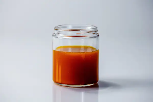 Palm Oil for Babies a glass jar of palm oil, which has a dark orange color