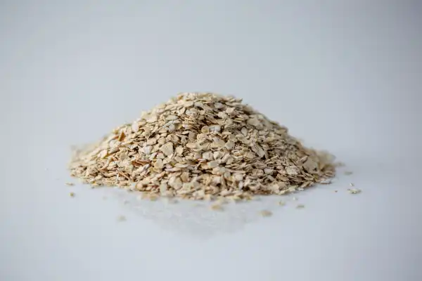 a pile of quick oats on a white background for babies starting solids