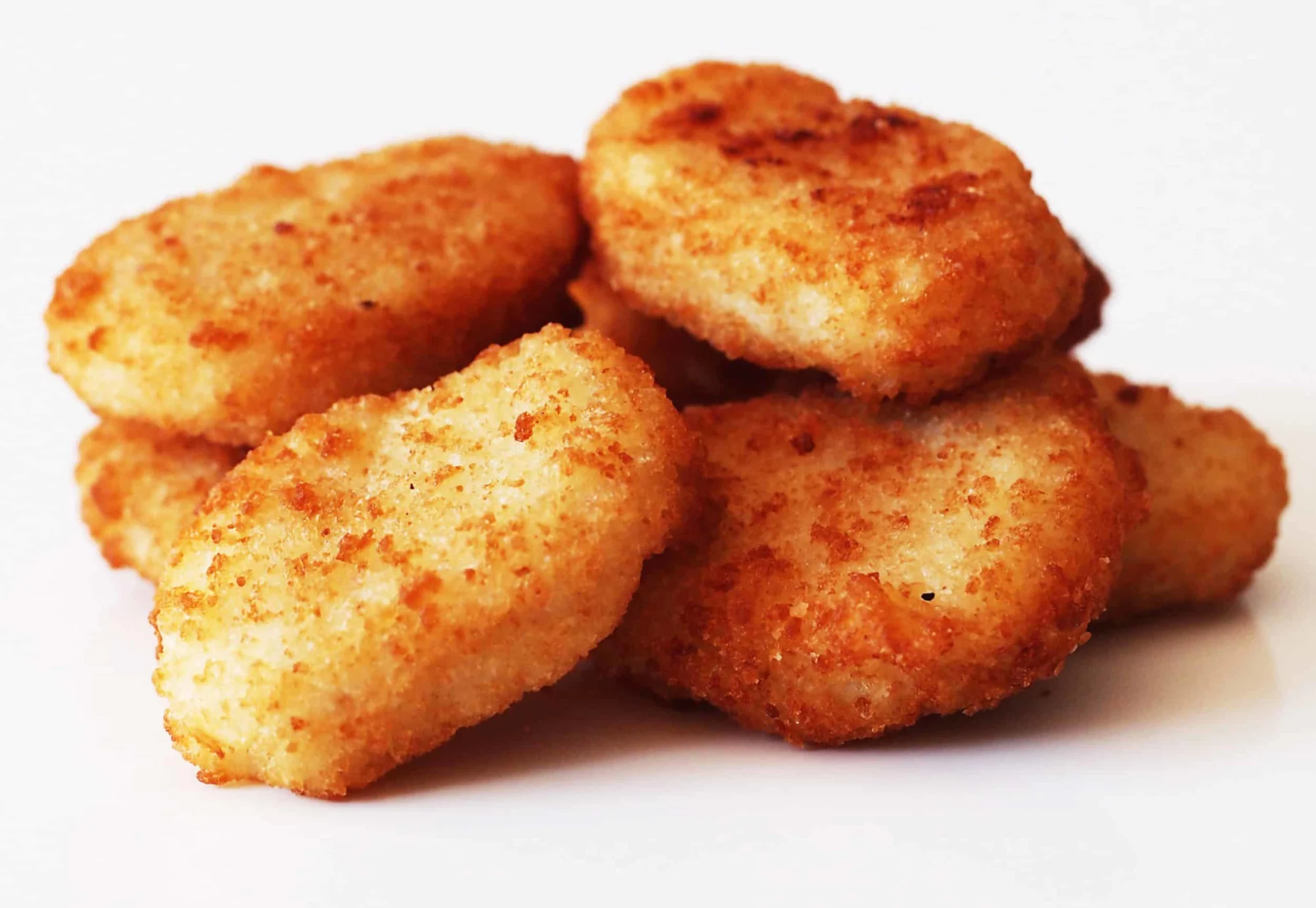 a pile of chicken nuggets on a table before being prepared for babies starting solid food