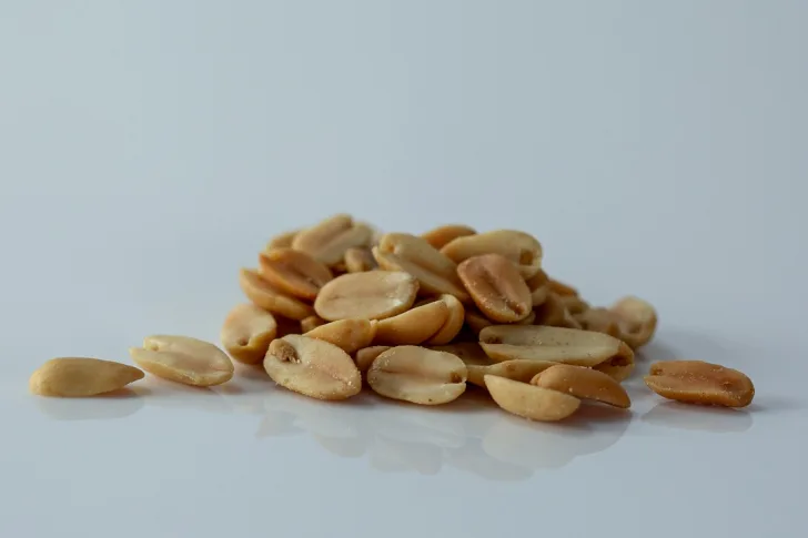 a pile of roasted peanuts on a table before being prepared for babies starting solid food