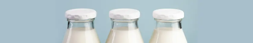 Three glass bottles of milk