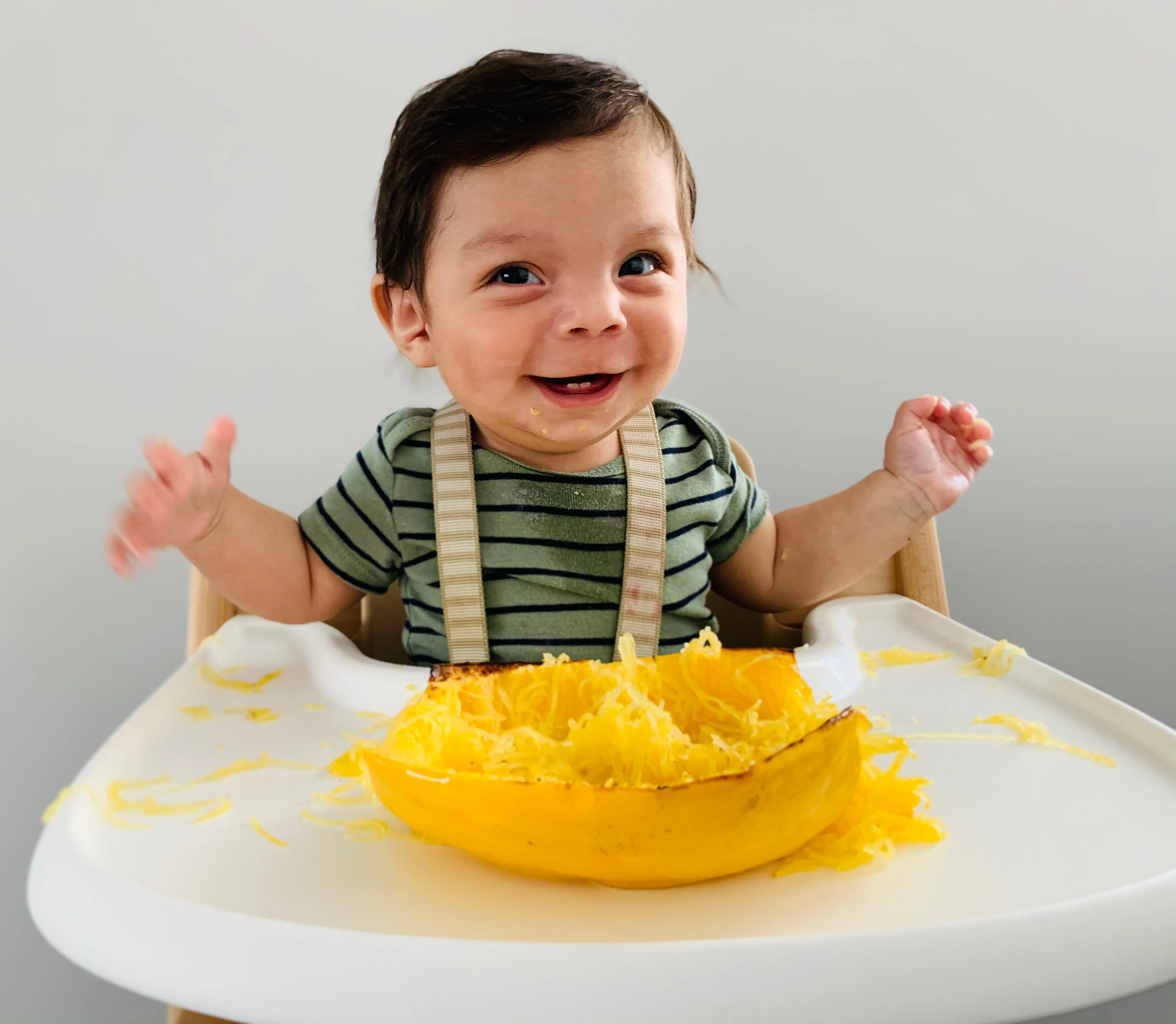 Sebastiȧn, 6 months old, explores spaghetti squash.