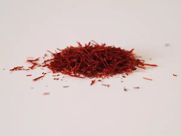 a photograph of a small pile of saffron threads on a white background