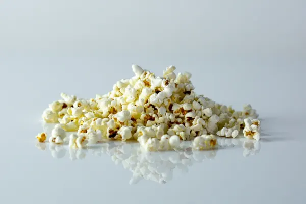 a handful of popcorn on a white background Solid Starts