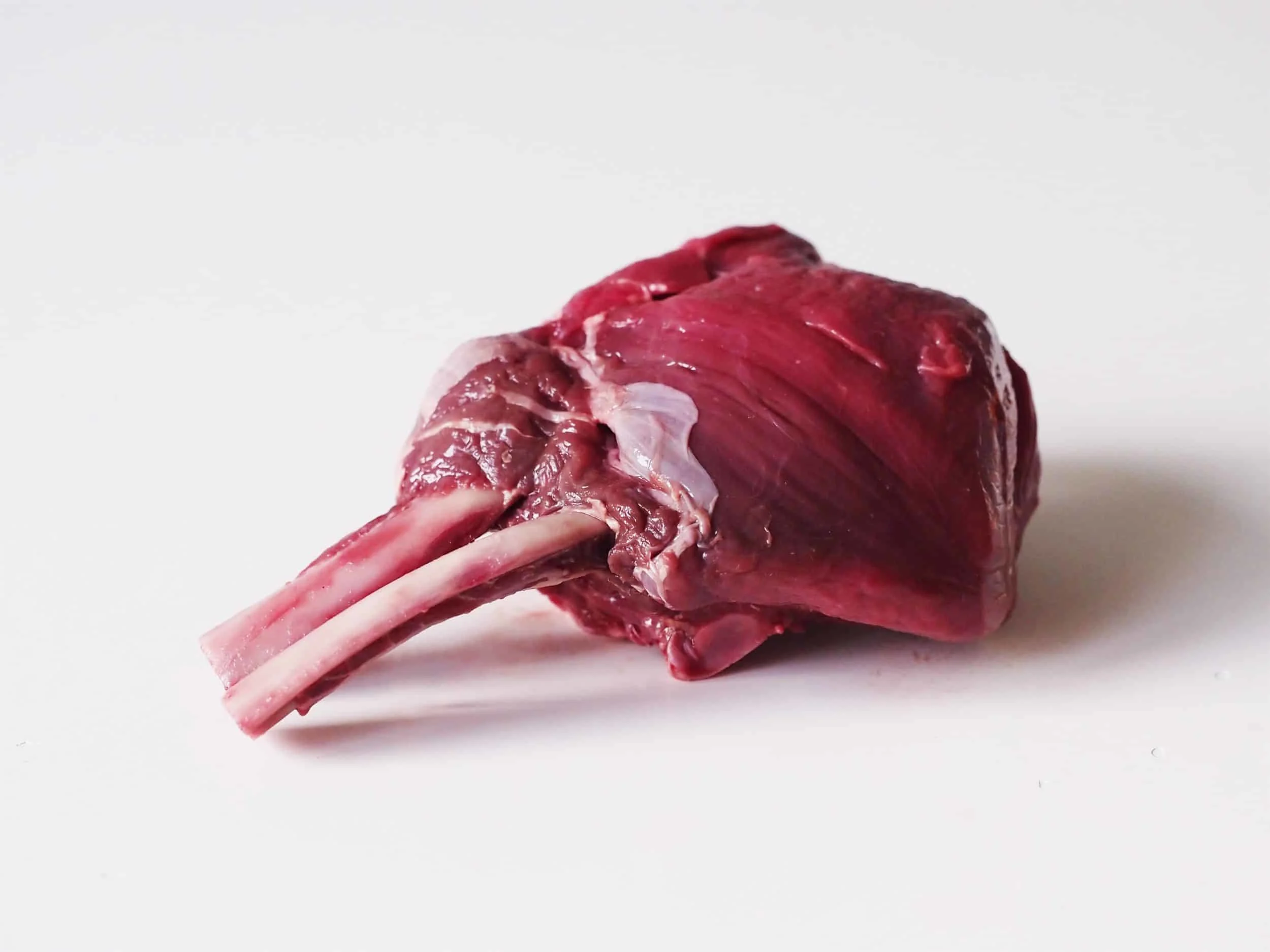 raw venison chops on a table before being prepared for babies starting solid food