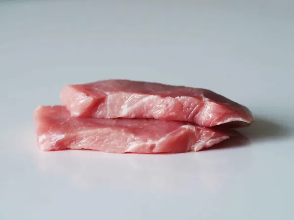 two pork cutlets before being prepared for babies starting solids