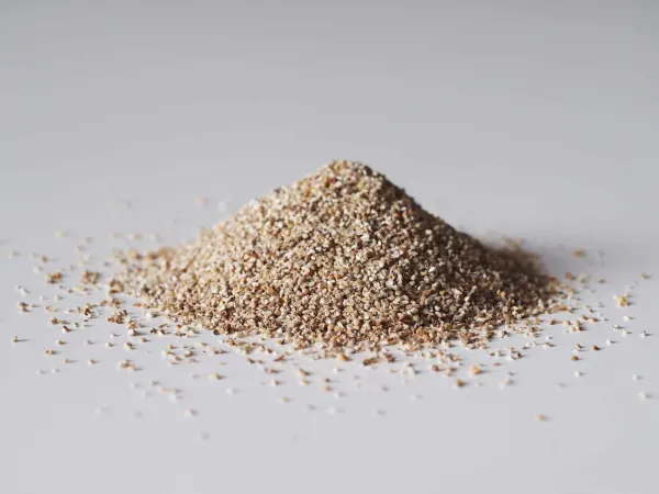 a pile of uncooked millet on a gray background ready to be cooked for babies starting solids