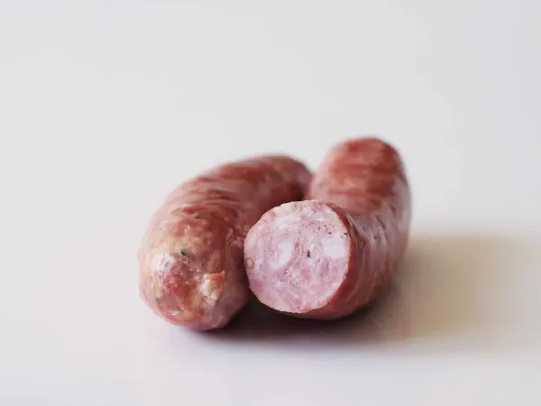 two pork sausage links before being prepared for babies starting solids