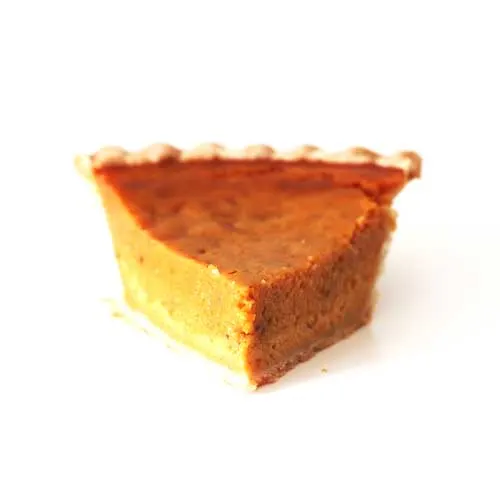 a photograph of a slice of pumpkin pie on a white background