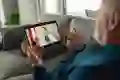 Senior man having video call with his doctor