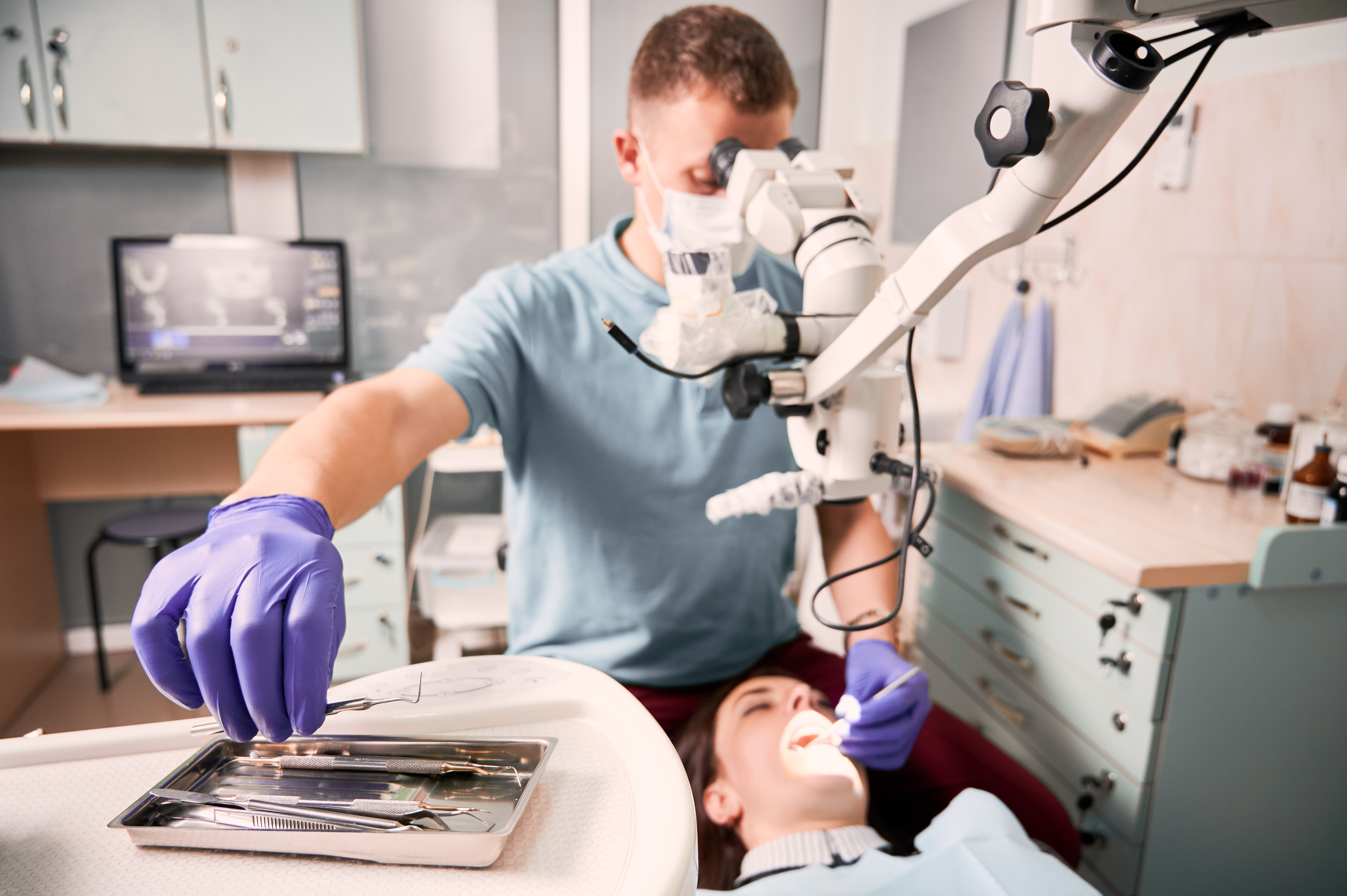 male-dentist-grabbing-dental-explorer-dental-procedure