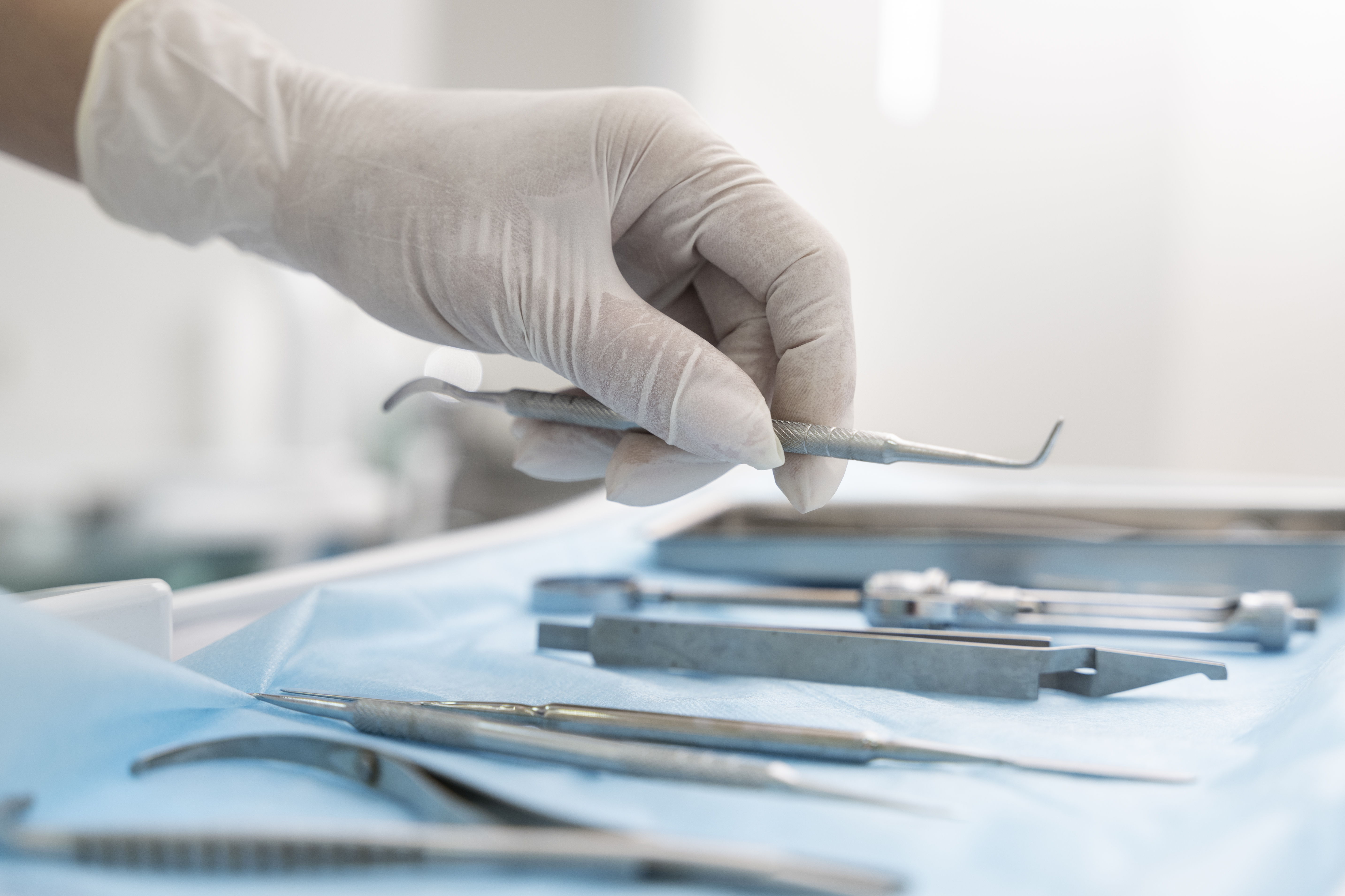 dentist-picking-up-utensil-teeth
