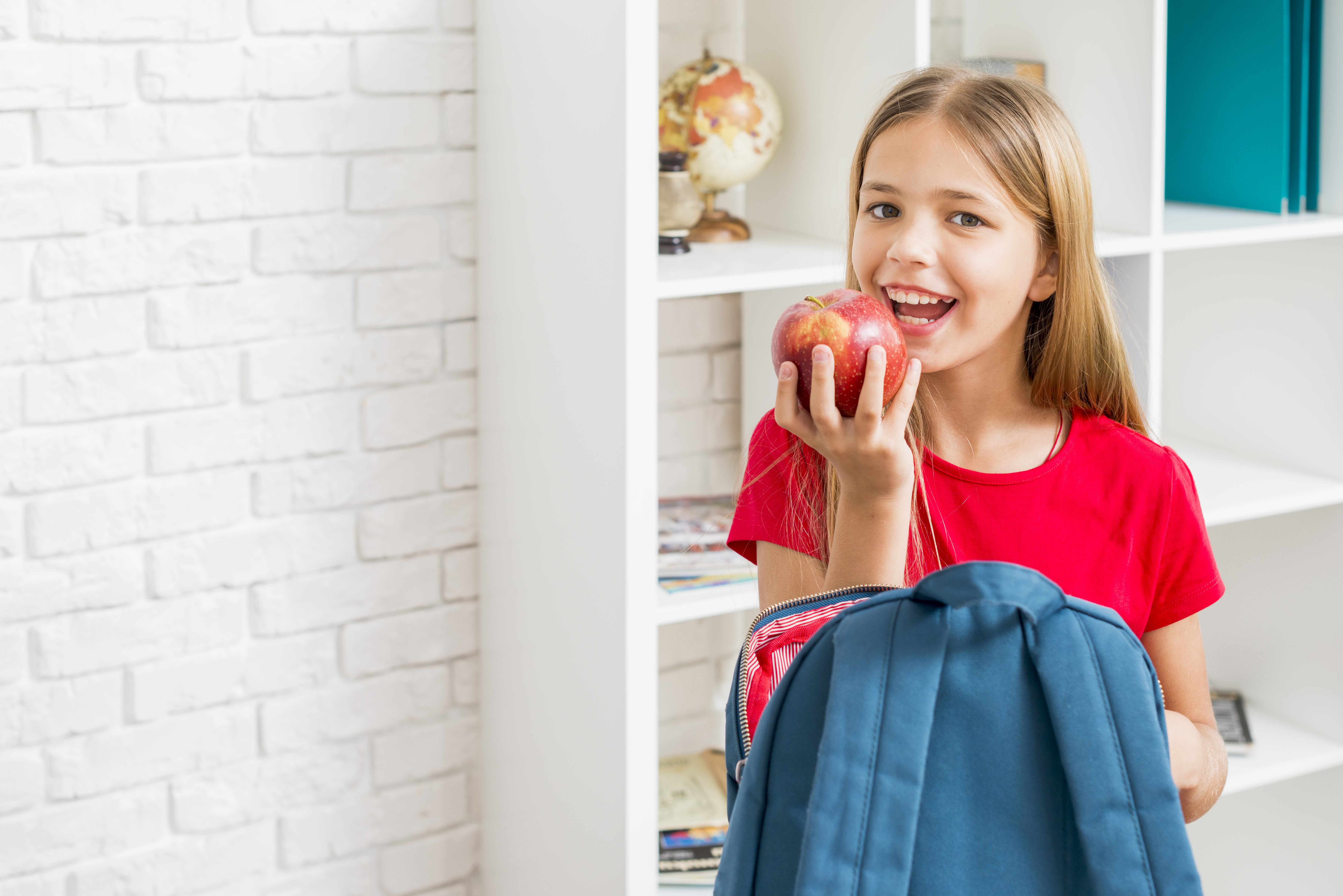 elementary-school-girl-intending-bite-apple