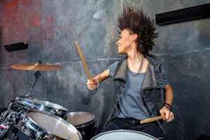 Why did the drummer keep banging her head against the drums? image