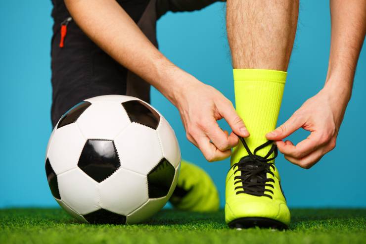  Why did the footballer hold his boot to his ear? image