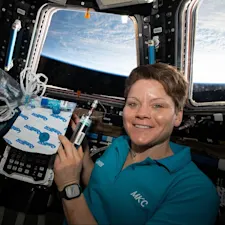 ISS-58 Anne McClain with biomedical gear inside the Cupola