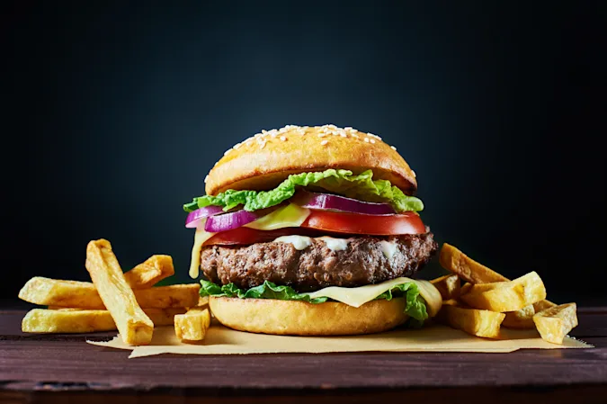 How many guys does it take to make a burger and fries? image