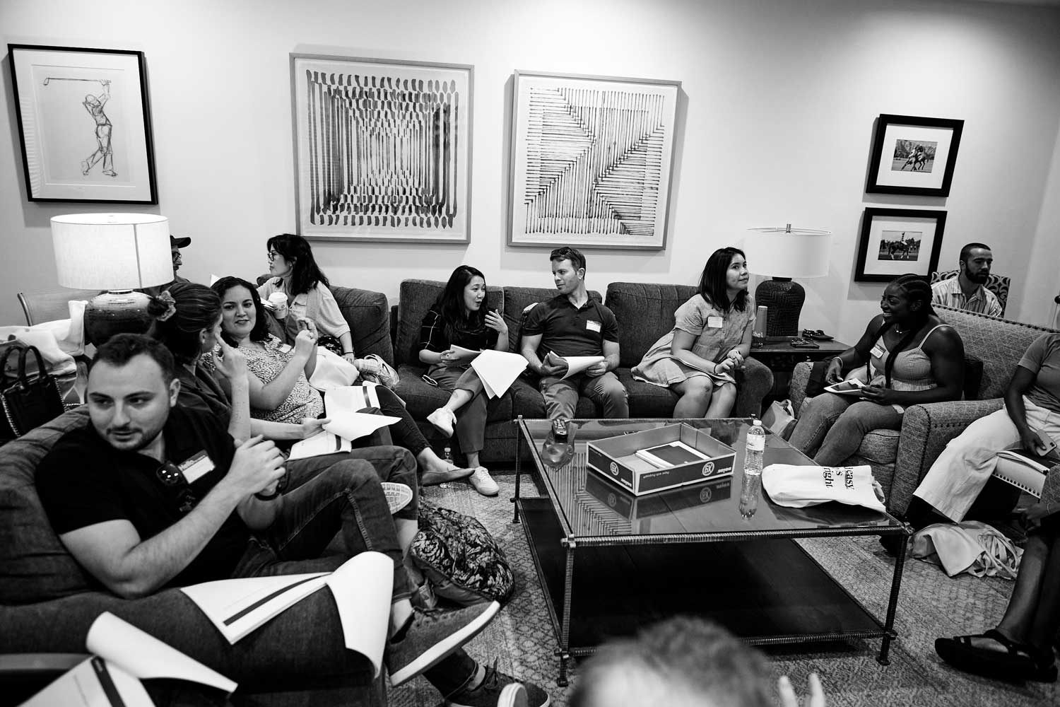 A group of people from the customer experience team at Atticus meet in a comfortable room.