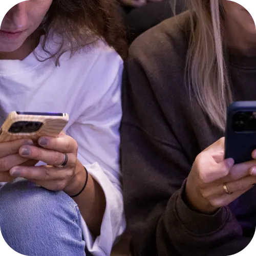 Two people looking at their phones