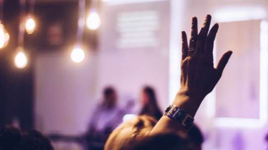 Raised hand at an event