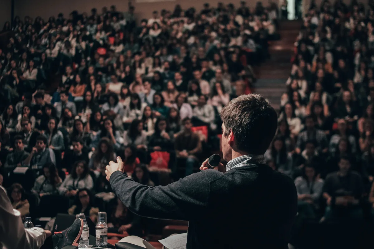 Man talking in front of an audience 