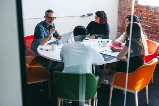 People in an office holding a meeting