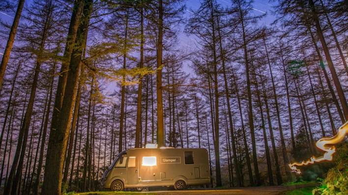GlamperRV at night in a forest. Photo owned by glamperrv.co.uk.