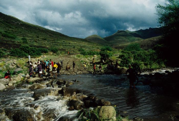 Group of people crossing water in Africa