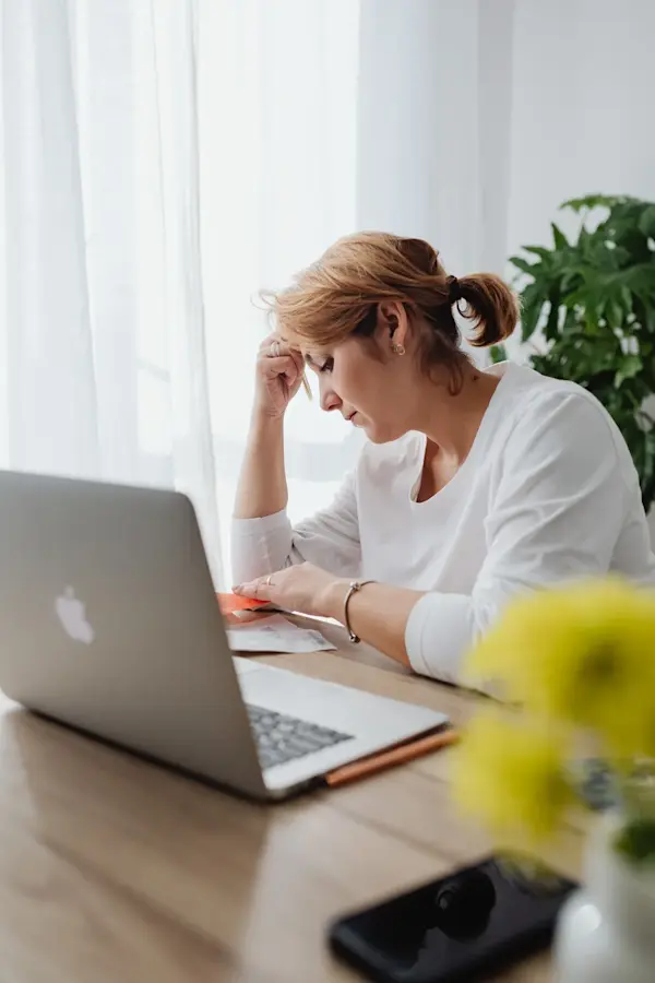 canva-worried-woman-sitting-in-an-office-in-front-of-her-laptop -MAENtRbFsAE