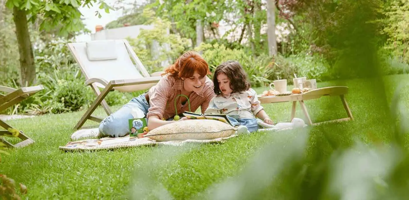 Mother and daughter sitting on the garden floor