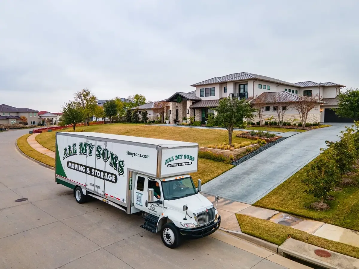 All My Sons moving truck parks out front of a beautiful new home, ready to move in.