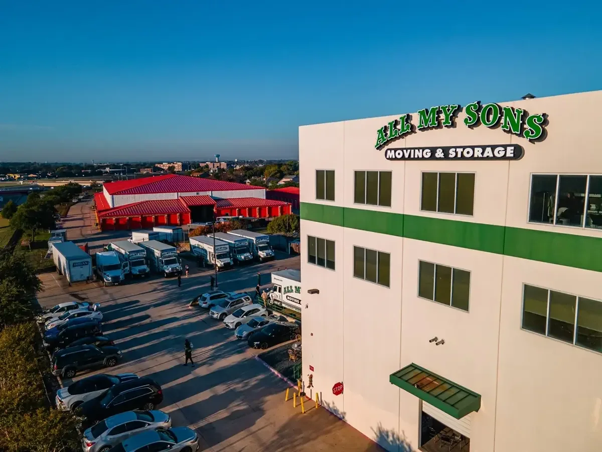 All My Sons Moving and Storage building with moving trucks parked behind it.