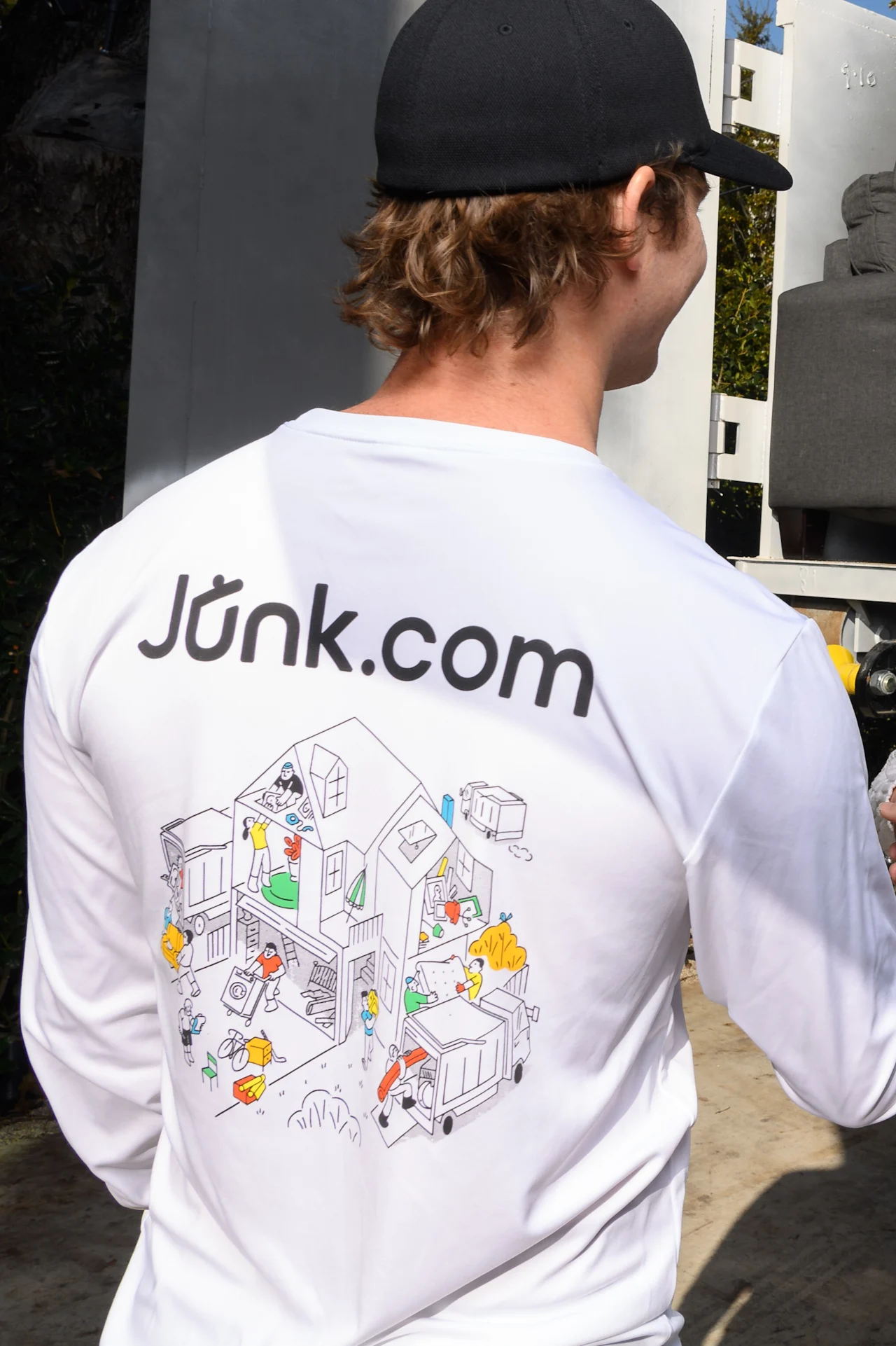 Junk removal specialist in a Junk.com shirt arrives at a same-day junk removal job.