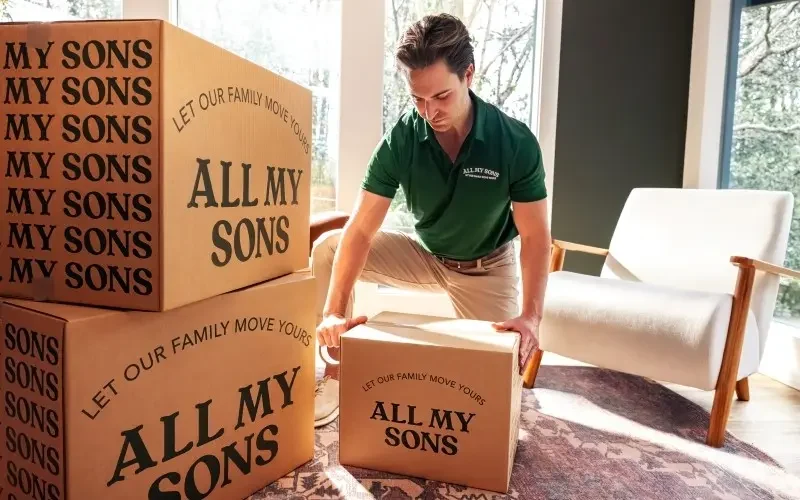 Local All My Sons Team Member lifts a box.
