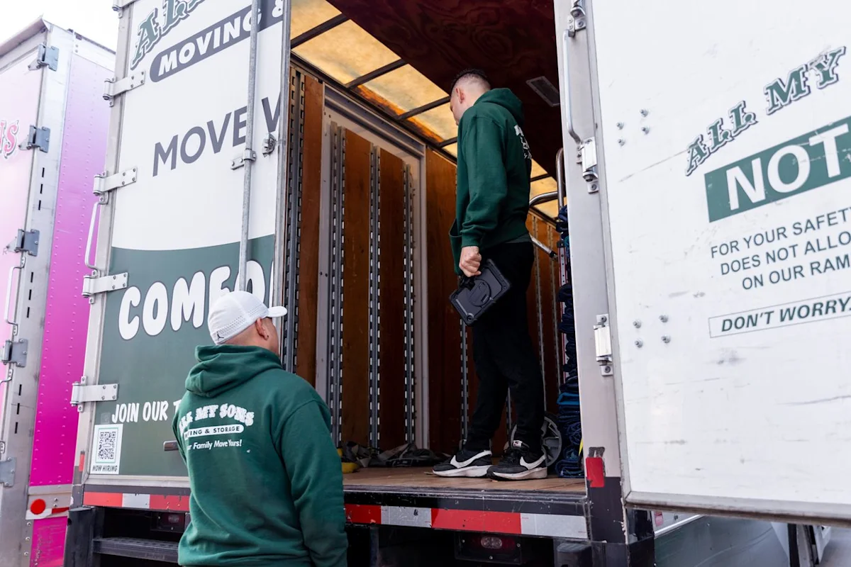 All My Sons professional movers ready an open truck to start a move into a storage unit.