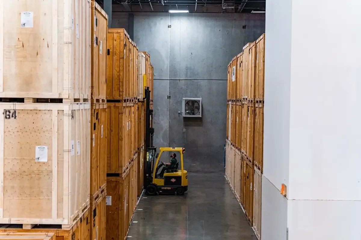 Forklift moves storage boxes at an All My Sons storage facility. 