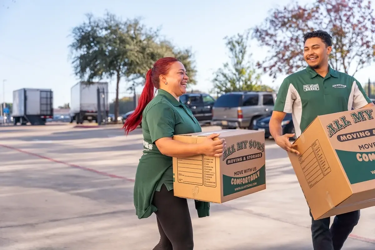 All My Sons team members carry moving boxes to the truck for a last-minute move.