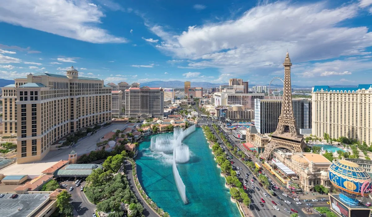 An aerial view of the famous Las Vegas strip including the Fountains of Bellagio and the prominent Paris Las Vegas Hotel & Casino.