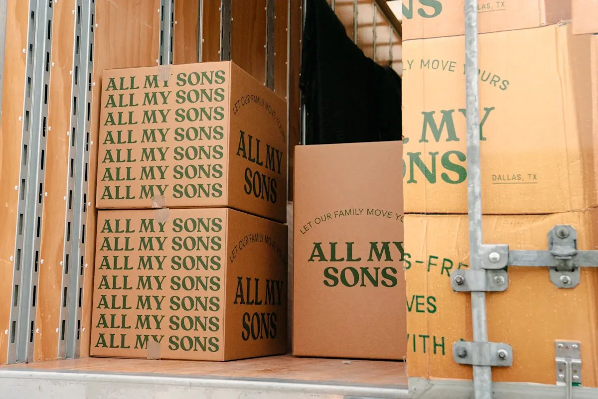 All My Sons Moving and Storage moving boxes stacked in the back of a truck. 