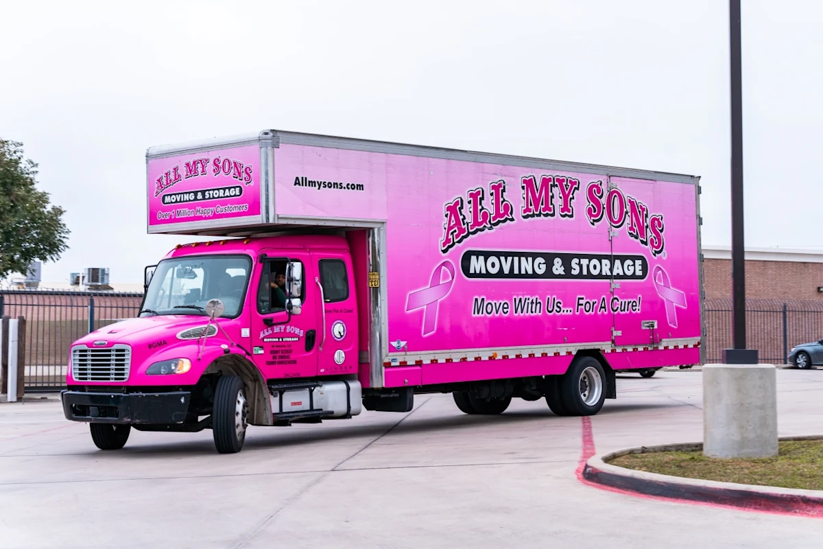 The All My Sons Moving & Storage branded pink truck for breast cancer awareness.