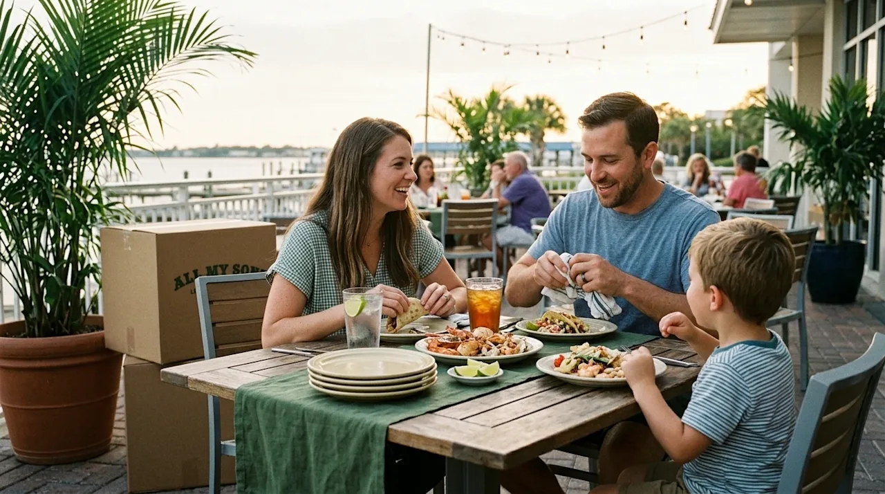 Authentic 35mm film lifestyle photography of a welcoming coastal restaurant patio in Pensacola, Florida. A joyful family is s