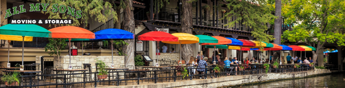 colorful umbrellas outside of restaurants along san antonio riverwalk