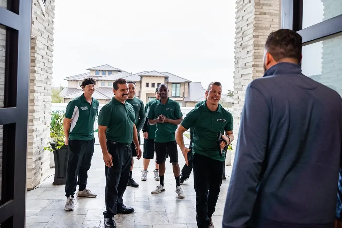 All My Sons local movers greet their customer at the doorway to his home.