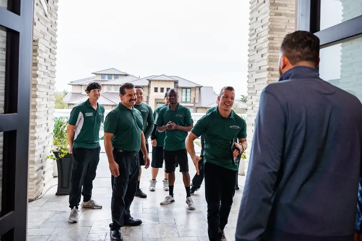 All My Sons local movers greet their customer at the doorway to his home.